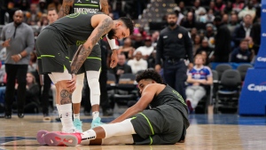 Timberwolves' Towns helped off with right leg injury