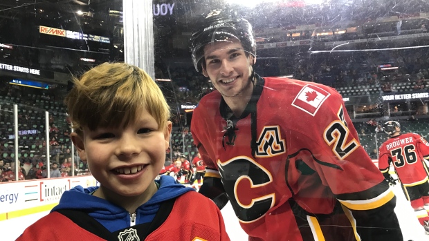 Mason Rodriguez with Sean Monahan before a game during the 2016-17 season. 
