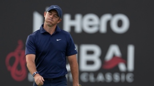 McIlroy, Reed tied behind leaders at Dubai Desert Classic