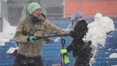 Workers shovel Highmark Stadium in Buffalo