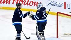 Dylan DeMelo and Connor Hellebuyck 