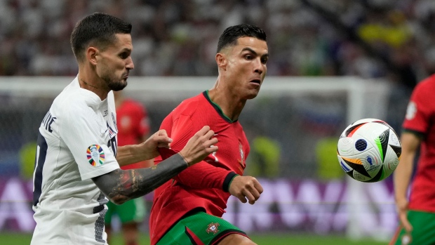 Petar Stojanovic, left, Cristiano Ronaldo