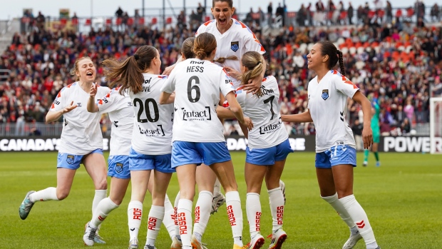 Montreal Roses FC forward Tanya Boychuk (12) is surrounded by her teammates