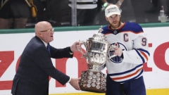 NHL deputy commissioner Bill Daly hands Clarence S. Thompson Bowl to Connor McDavid