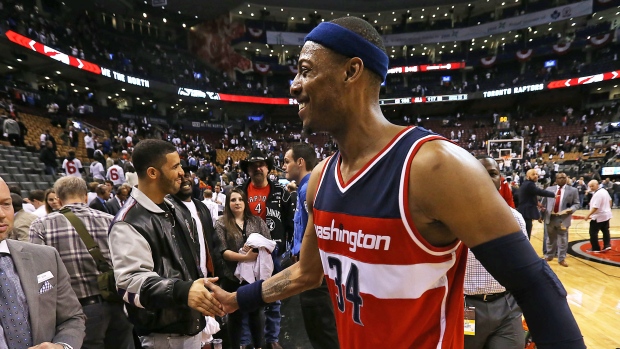 Drake shakes the hand of Paul Pierce