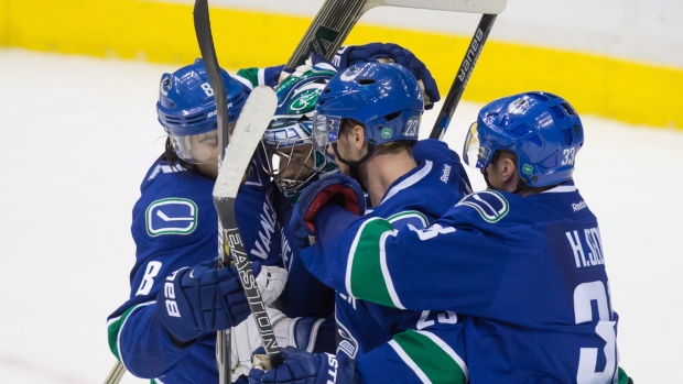 Chris Tanev Ryan Miller Alexander Edler Henrik Sedin, The Canadian Press Chris Tanev Ryan Miller Alexander Edler Henrik Sedin