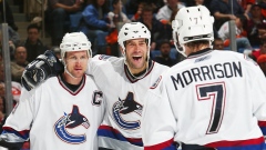 Todd Bertuzzi #44 of the Vancouver Canucks celebrates a goal with Markus Naslund #19 and Brendan Mor