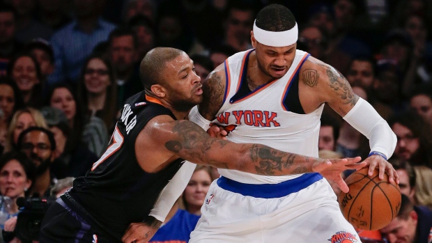 New York Knicks' Wilson Chandler goes up with a shot as he is guarded by New  Jersey Nets' Sean Williams, left, and Bobby Simmons (21) during the fourth  quarter of an NBA