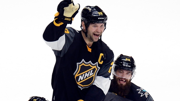 Teammates lift John Scott , The Canadian Press Teammates lift John Scott