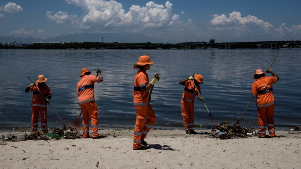 Workers collect floated debris on a beach at Guanabara bay, YASUYOSHI CHIBA/AFP/Getty Images Workers collect floated debris on a beach at Guanabara bay