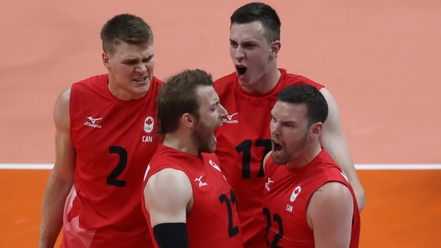 Canadian volleyball players celebrate, Buda Mendes/Getty Images Canadian volleyball players celebrate