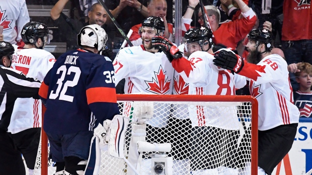 Team Canada celebrates behind Quick, The Canadian Press Team Canada celebrates behind Quick