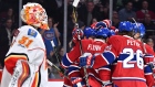 Canadiens celebrate in front of Johnson