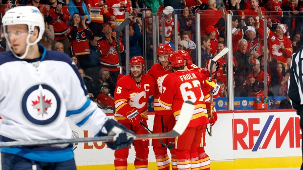 Mark Giordano, Dougie Hamilton and Flames celebrate