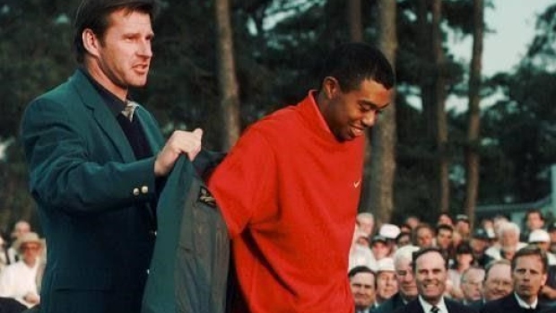 Nick Faldo hands green jacket to Tiger Woods