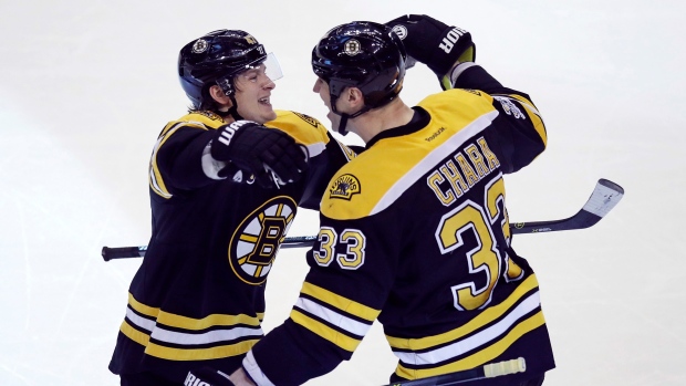 Torey Krug and Zdeno Chara celebrate goal