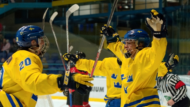Sweden's Jacob Olofsson celebrate, IIHF-HHOF/Images on Ice Sweden's Jacob Olofsson celebrate