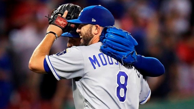 Mike Moustakas and Kelvin Herrera celebrate