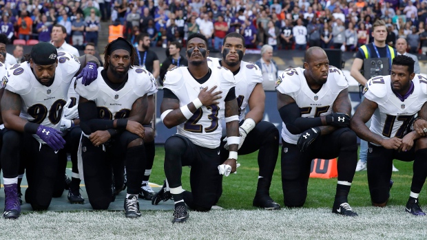 Ravens players kneel during national anthem in London