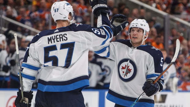 Tyler Myers and Dmitry Kulikov celebrate goal