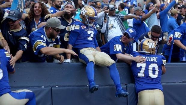 Weston Dressler celebrates with Blue Bombers fans