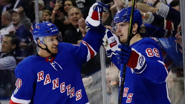 Michael Grabner and Pavel Buchnevich celebrate goal