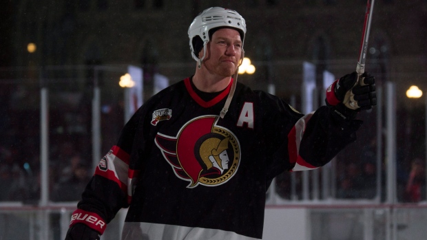 Former Ottawa Senators player Chris Neil and his family watch as a