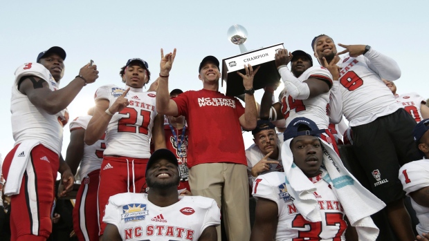 North Carolina State celebrates with the Hyundai Sun Bowl, The Canadian Press North Carolina State celebrates with the Hyundai Sun Bowl