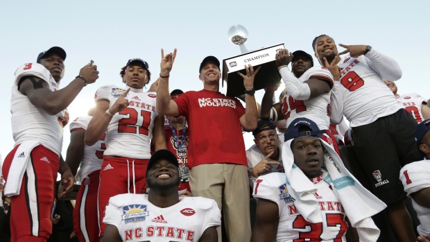 North Carolina State celebrates with the Hyundai Sun Bowl