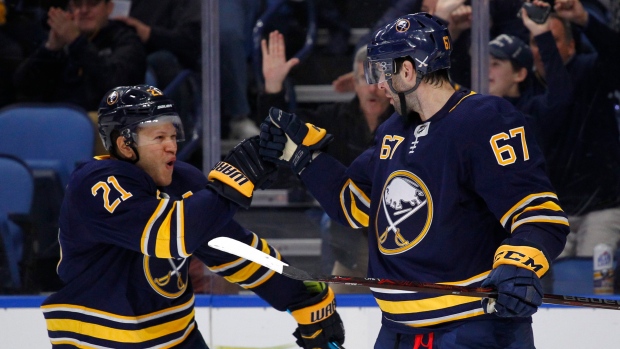 Kyle Okposo and Benoit Pouliot celebrate goal