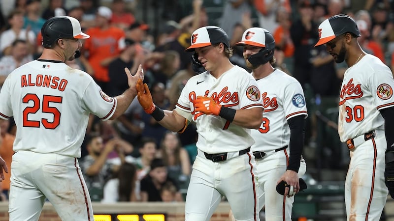 Holliday hits grand slam, Young pitches Orioles past Mariners to stop four-game slide