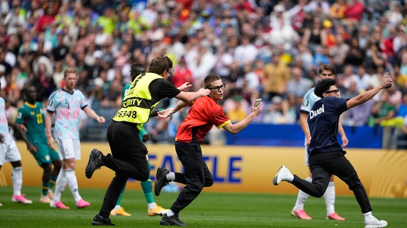Three people run onto field and stop play during the World Cup match between Belgium and Senegal