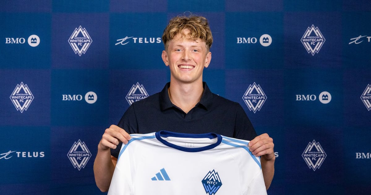 Valter Sedin posing with a Vancouver Whitecaps FC jersey after signing a professional contract.