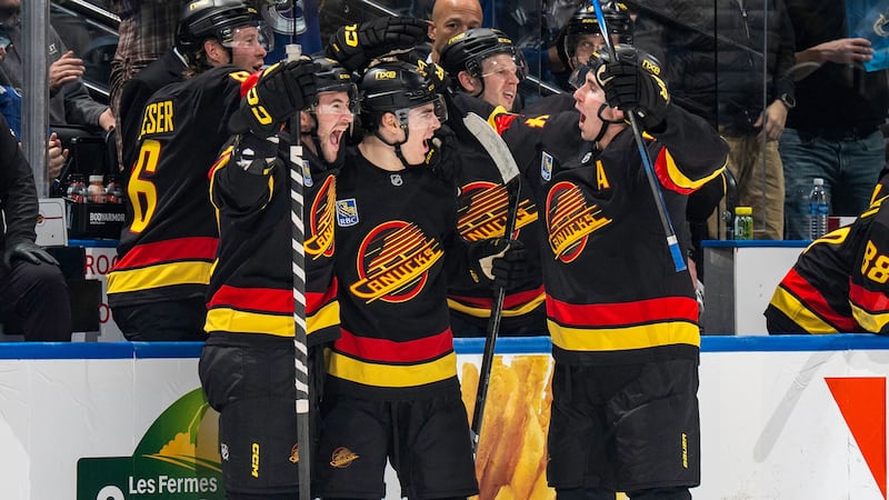 Canucks score four unanswered goals in third to top Flames
