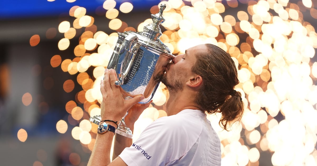 Photo: TSN Alexander Zverev, of Germany, kisses the trophy after winning the men's singles final of the U.S. Open tennis championships