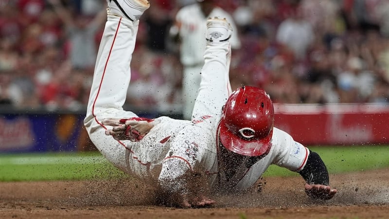 Reds score twice in eighth on wild pitches to beat Athletics