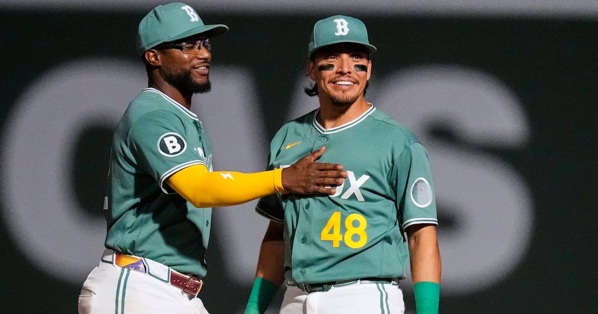 Photo: TSN Boston Red Sox's Anthony Seigler (48) smiles while celebrating with Andruw Monasterio, left, after their team defeated the