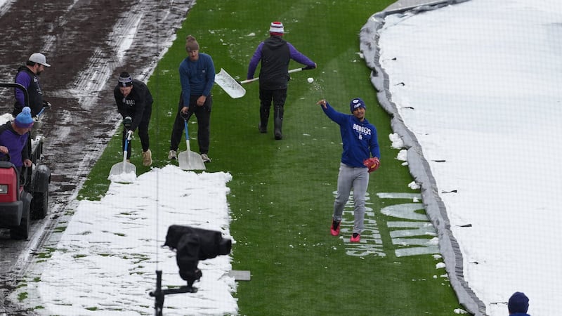 Surprise mid-April snow coats Coors Field as Dodgers-Rockies series gets off to frosty start