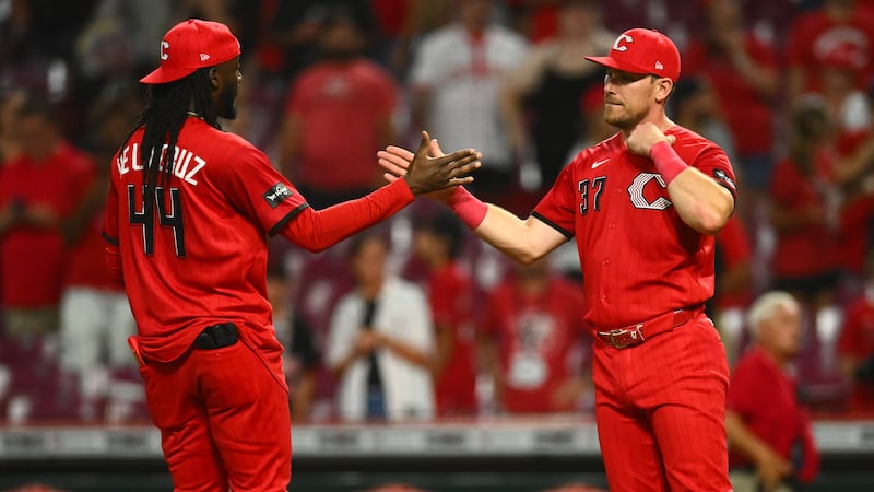 Reds hit three home runs, hold on for victory over Brewers