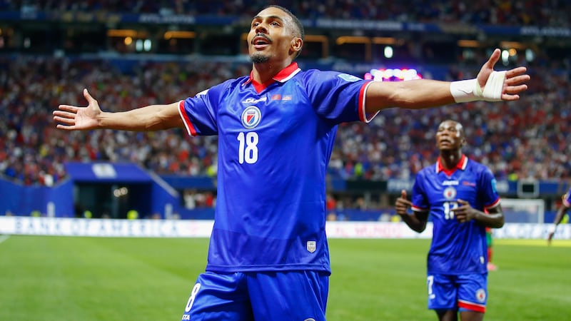 Members of Haiti's national soccer team tour their capital after playing in the World Cup