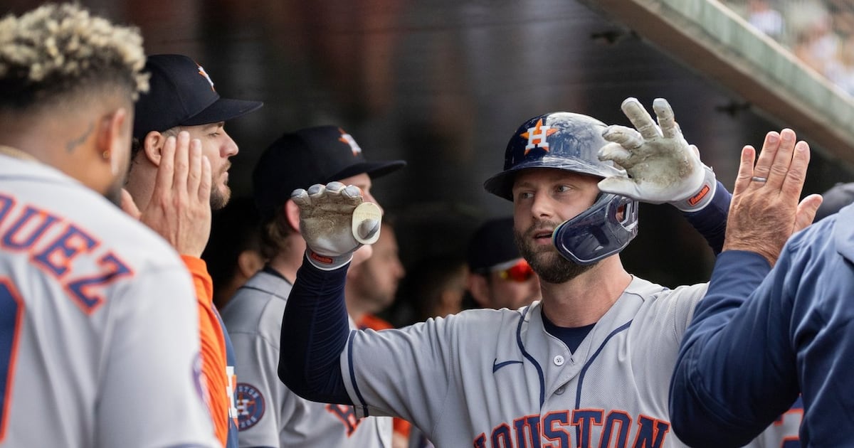 Houston Astros players celebrate on the field.