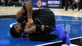 Anthony Edwards helped to the locker room after awkward landing