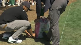 Xander Schauffele's tee shot somehow ends up in patron's bag